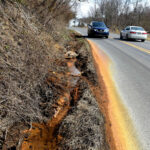 acid mine drainage on side of the road